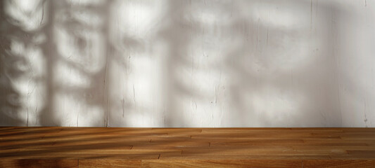 Wooden table in the kitchen and rustic white wall with natural shade of trees and leaves, light shining through the window 