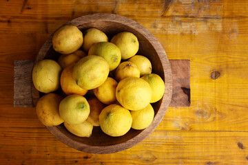 Naklejka na ściany i meble Image of group of fresh lemons over old vintage wooden table
