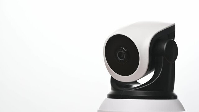 Surveillance IP Internet CCTV camera system remotely operated. Smartphone controlled home security camera moving filming around in 4k footage isolated on white background.