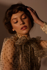 Portrait of a beautiful girl with an unusual hairstyle and natural make-up in the studio on dark background