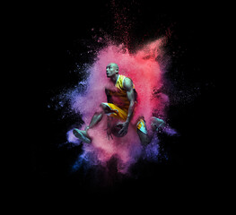 One young sportsman basketball player in explosion of colored neon powder isolated on black background - obrazy, fototapety, plakaty