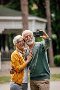 Mature husband, making a self portrait, with his wife.