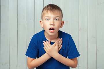 Wow, I canT believe this. Portrait of astonished preteen boy in blue t shirt with stunned shocked...