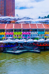 Fototapeta na wymiar View of tourist wooden boat floating on Singapore river with downtown buildings in the background,