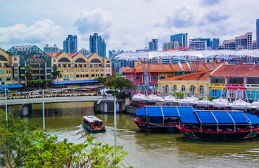Fototapeta na wymiar View of tourist wooden boat floating on Singapore river with downtown buildings in the background,
