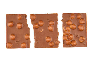 Macro photo of Chocolate bar. Broken pieces over white background. Milk chocolate pieces isolated on white background