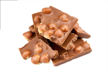 Macro photo of Chocolate bar. Broken pieces over white background. Milk chocolate pieces isolated on white background