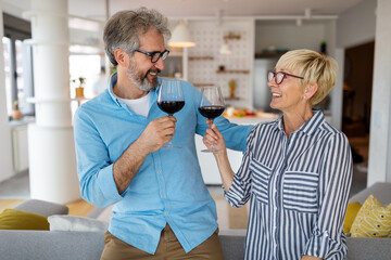 Cheerful senior couple enjoying life together, having fun at home