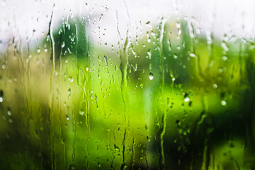 rainy weather. drops and jets of rain on glass close-up
