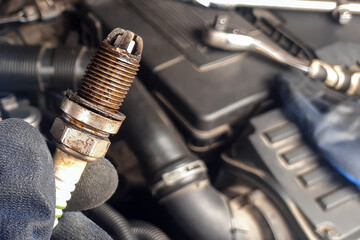 Old car candle on engine background in human hand. Mechanic concept. repair