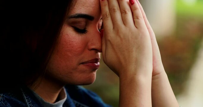 Spiritual person praying to the divine. Young woman prayer