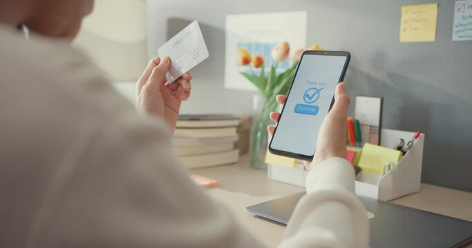 Closeup young asia lady use cellphone order online shopping product and pay bills with credit card in living room interior at house, Self quarantine activity, Fun activity for coronavirus prevention.