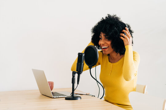 Positive young African American woman talking at online radio station