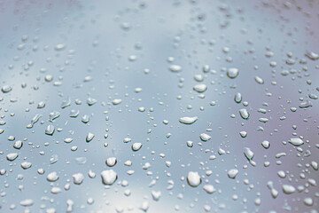 rainy weather. drops and jets of rain on glass close-up