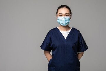 Young beautiful Asian Chinese medicine doctor woman or hospital nurse in scrubs using protective...