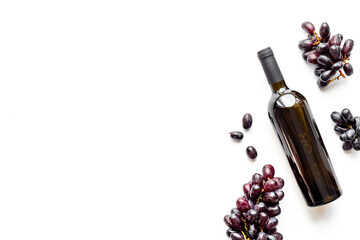 Top view of red wine bottle isolated with grape