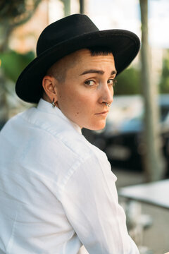 Stylish tomboy with piercing in hat
