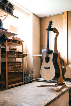 Acoustic guitars against manual instruments in workshop
