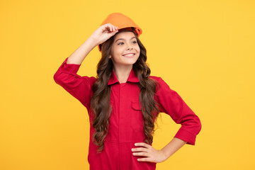 cheerful child girl in protective hard hat, labourer