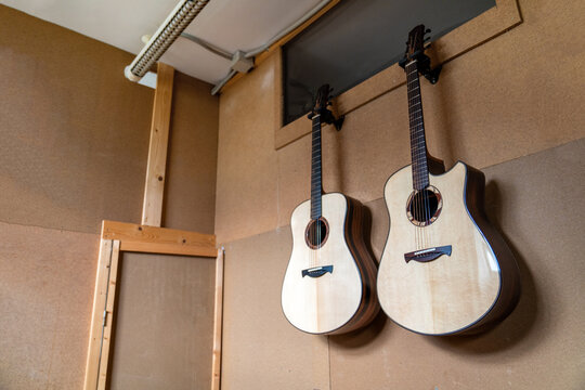 Acoustic guitars against manual instruments in workshop
