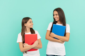 pupil and student. mom and teen girl ready to study. private teacher and child holding copybooks
