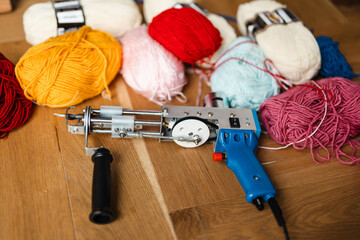 Photo of sewing machine and threads on wooden floor
