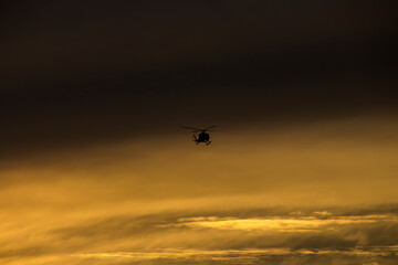 A helicopter coming from its flight during dusk