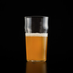 Half glass of light appetizing tasty lager with foam
