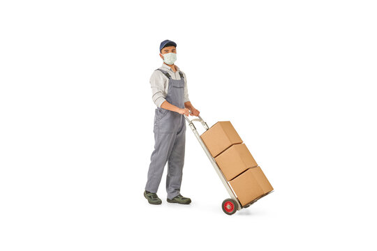 Delivery man pushing and pointing out hand truck, trolley isolated on white background.