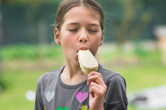 Young girl eating ice cream. Holiday and summer concept.
