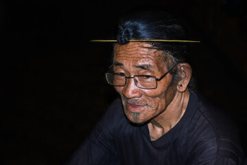 apatani tribal men facial expression with his traditional hair style and black background
