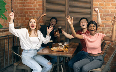 Group of friends watching sport match together. Concept of friendship, leisure activity, emotions