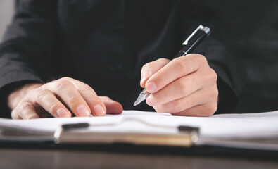 Male Judge signing in document. Justice and Law concept
