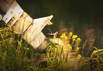 The propeller of the boat that's out of water is behind the yellow wildflowers at this body of water in Broome County in Upstate NY.  The warm morning sun light gives it a fantasy feeling.   © Chet Wiker