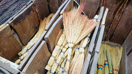 A lot of brooms on the window of the construction store