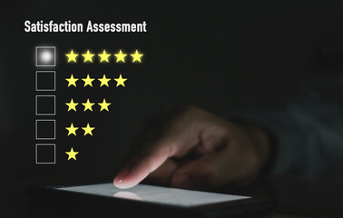 A young business man is using a new touch to a virtual screen in a 5-star customer satisfaction assessment concept.
