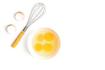 Top view of an egg, egg yolk, whisk, Eggshell   on a white background.