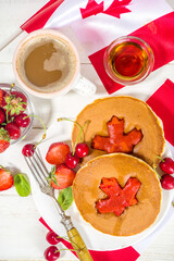 Canada Day concept, brunch menu background. Stack of red and white pancakes with maple leaf creative decoration, idea fod Canada Day breakfast food 