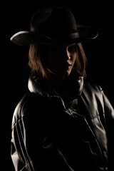 silhouette of a young woman with a cowboy hat