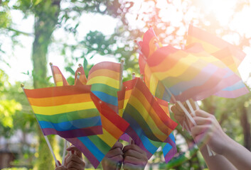 LGBT, pride, rainbow flag as a symbol of lesbian, gay, bisexual, transgender, and queer pride and LGBTQ social movements in June month - obrazy, fototapety, plakaty
