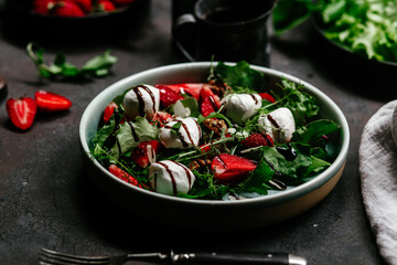 Salad with strawberries, mozzarella and arugula