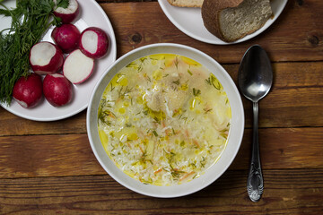 Homemade rice soup on a wooden table. Nutritious lunch. Healthy nutrition concept