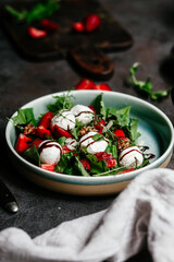 Salad with strawberries, mozzarella and arugula