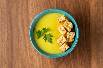 Bowl with onion soup and croutons on the table.
