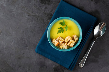 Bowl with onion soup and croutons on the table.