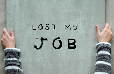 Lost my job, text on heavy stone plate in two weak female hands. Flat lay, depression, anxiety,...
