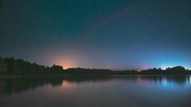 Lyepyel District, Vitebsk Province, Belarus. Real Colorful Night Stars Above Lepel Lake. Natural Starry Sky Background Backdrop Landscape. Time lapse. 4K