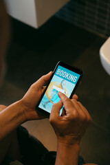 man books his vacation online in the bathroom