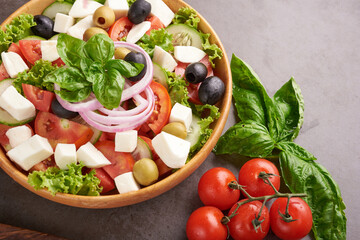 Classic greek salad of fresh vegetables, cucumber, tomato, sweet pepper, lettuce, red onion, feta...