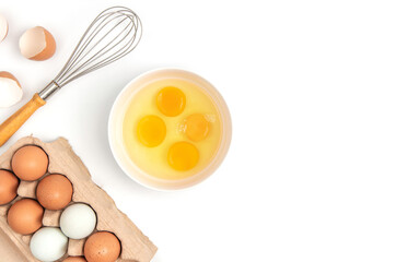 Top view  carton box eggs, egg yolk, whisk, Eggshell on a white background.
